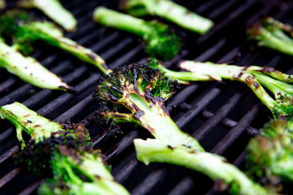 Close up of charred broccoli on a grill. 