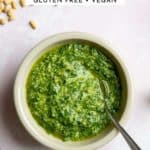 A bowl of mint pesto with a spoon.