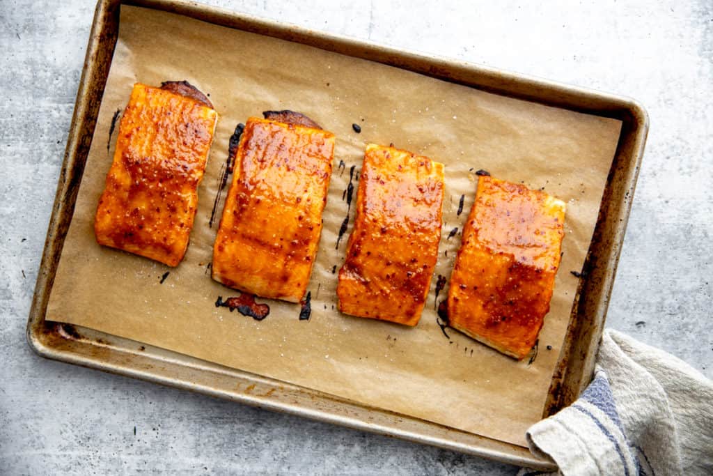 Miso glazed salmon on a parchment lined baking sheet.
