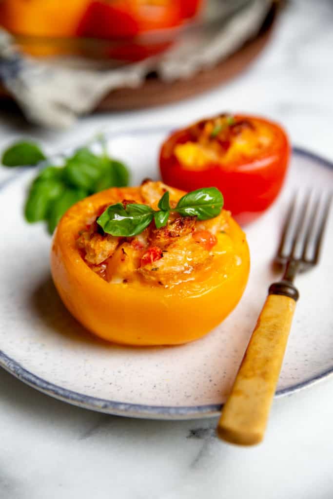 Stuffed baked tomato with an herb on top.