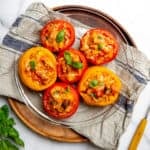 The best Panzanella stuffed baked tomatoes served on a plate.