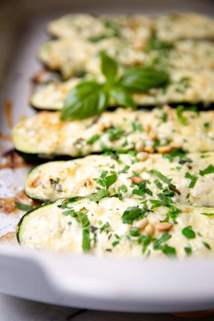 Baked stuffed zucchini with sprinkled herbs.