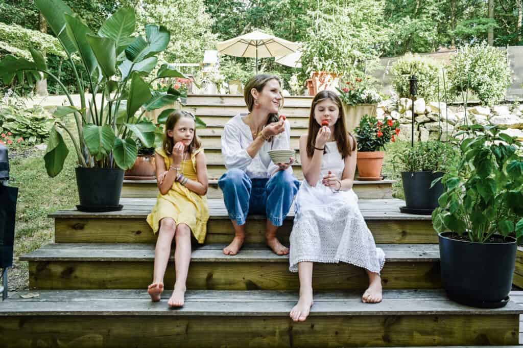 Nicki Sizemore sitting outside with her daughters.