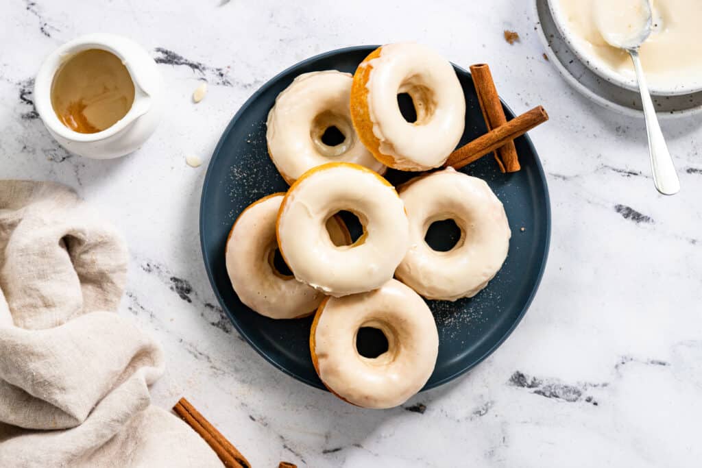 Maple glazed donuts on a blue plate.