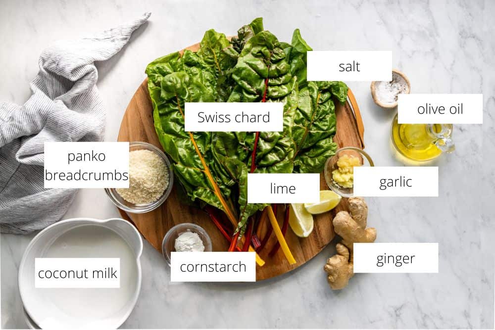 All of the ingredients for the Swiss chard gratin recipe arranged on a marble surface.