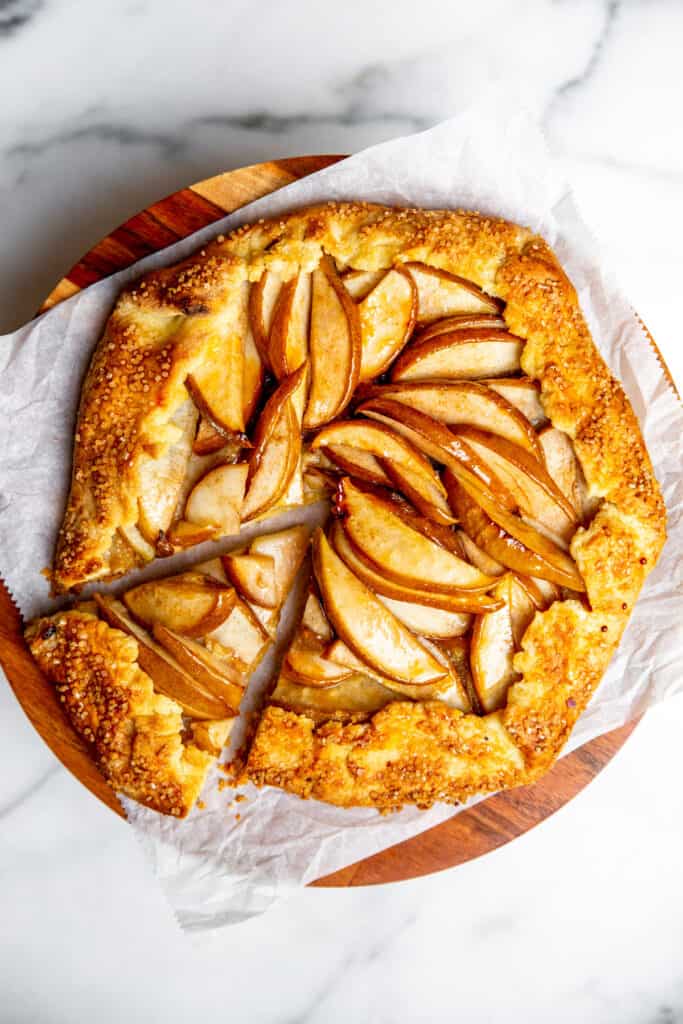 A gluten free pear galette on a cake stand. 