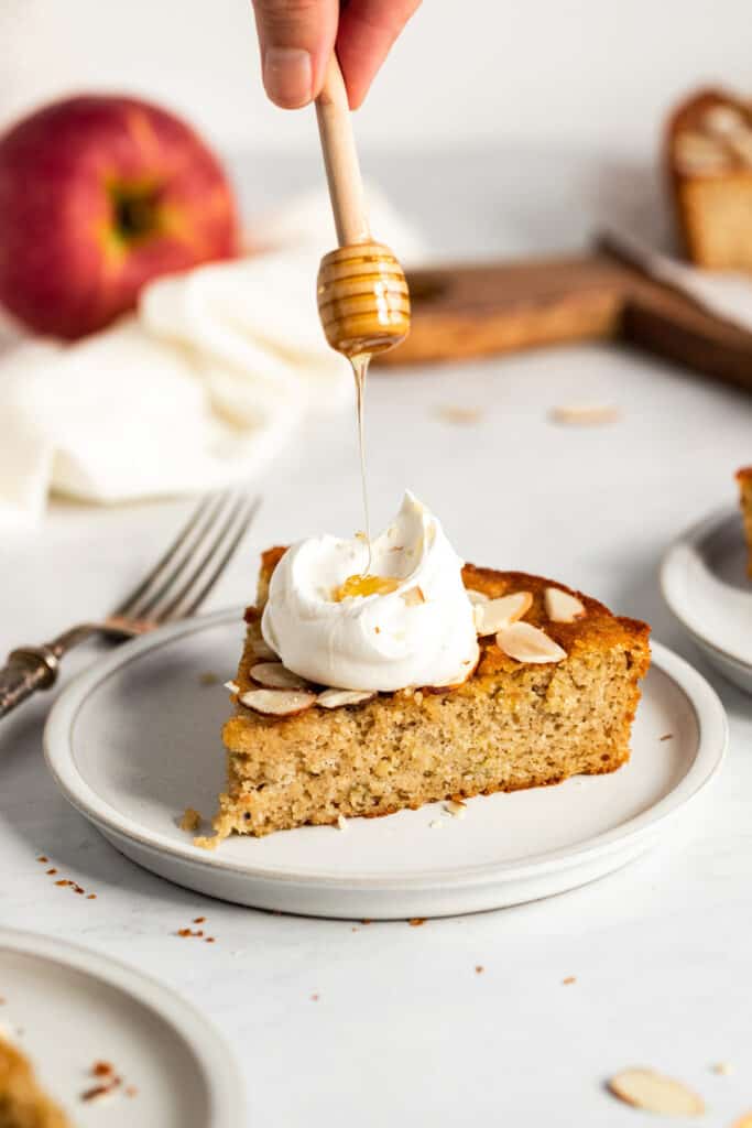 A slice of gluten free apple cake with honey.