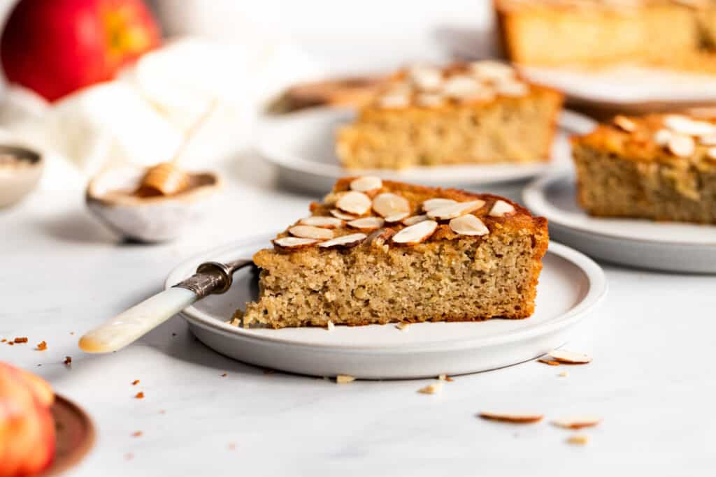 Slices of apple cake with almond toppings.