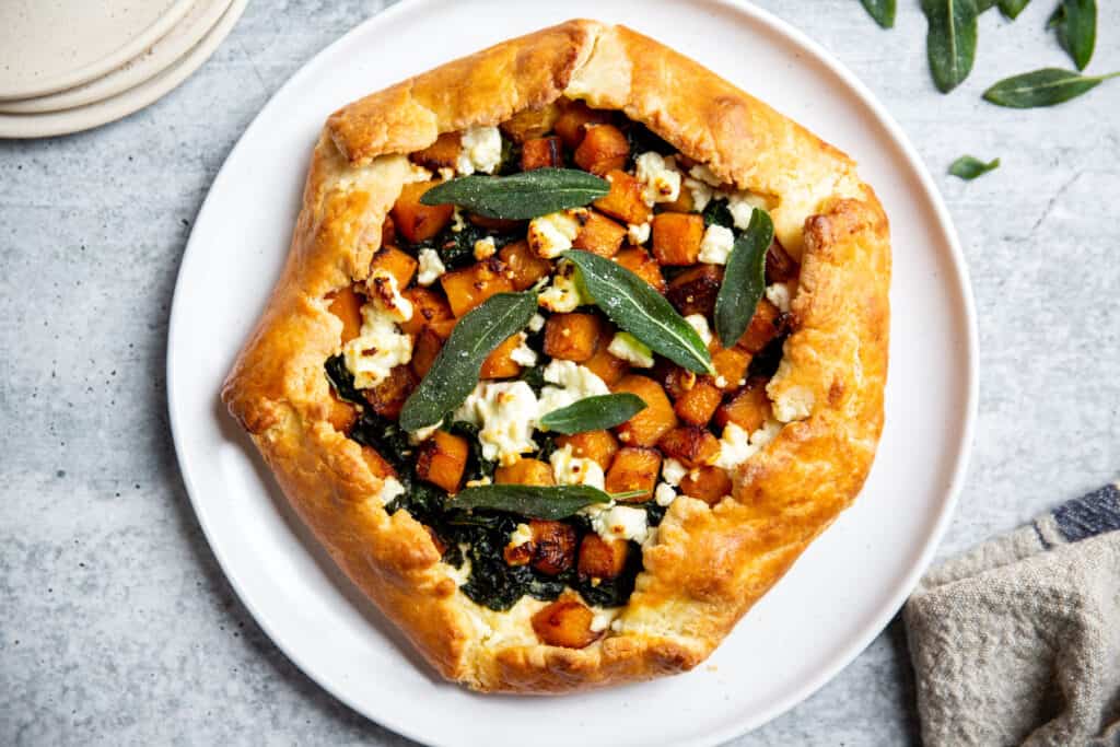 Butternut squash savory galette on a serving plate.