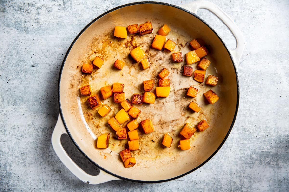 Sauteed butternut squash in a skillet.