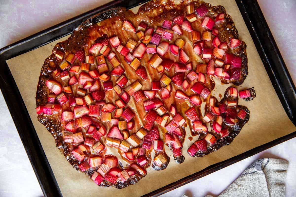 caramelized and roasted rhubarb and strawberries on a baking sheet