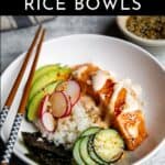A spicy salmon rice bowl with chopsticks.
