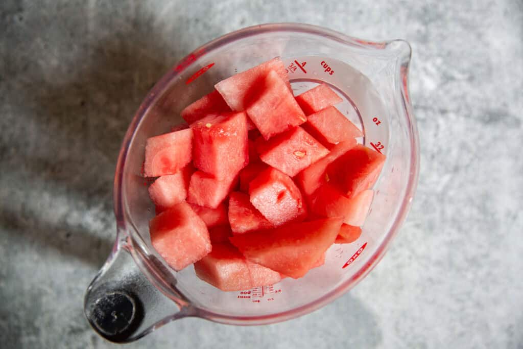 watermelon cubes in a measuring cup