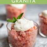 Watermelon granita in a glass topped with whipped cream.