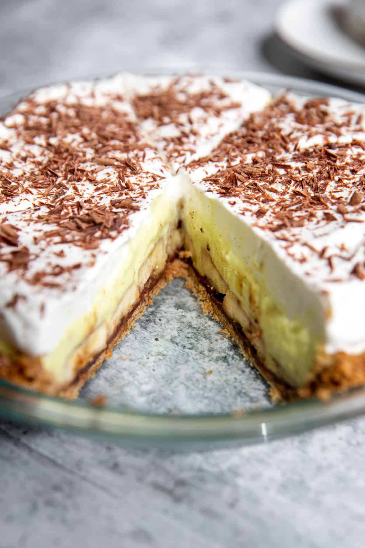 an upclose shot showing the banana cream pie with a slice take out