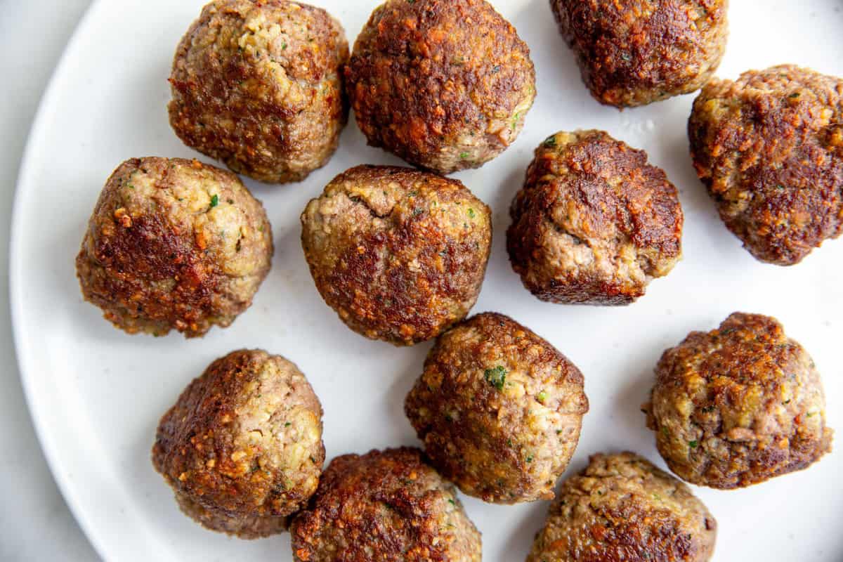 an overhead shot of bison meatballs on a white surface