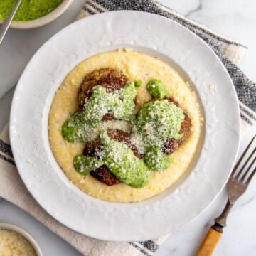 bison meatballs on top of grits and covered with italian salsa verde
