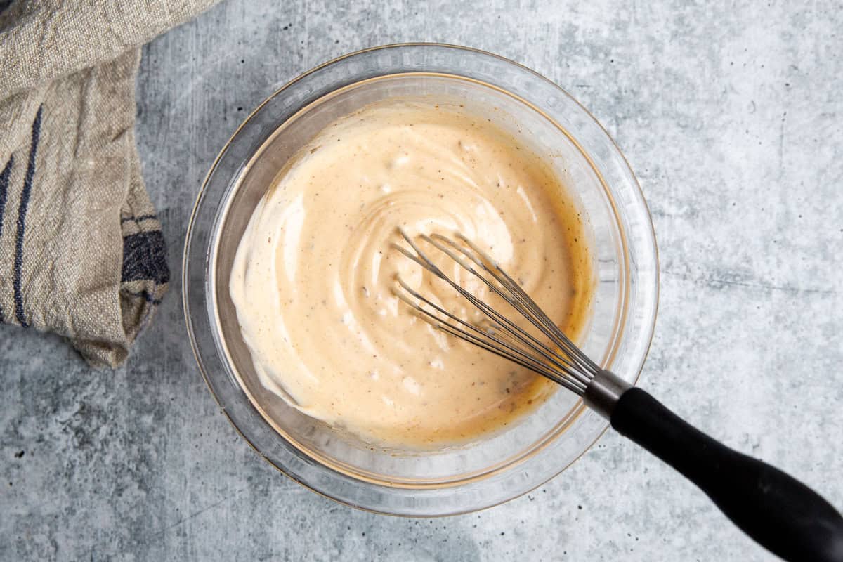 chili crisp sauce in a bowl with a whisk