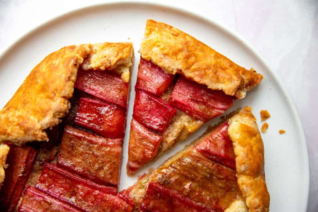 an up close shot of a slice of galette topped with rhubarb