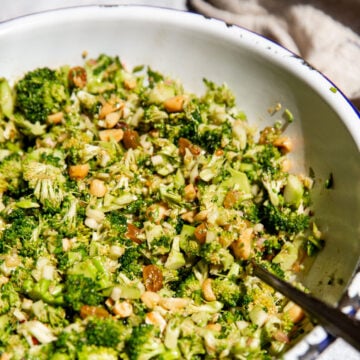 broccoli crunch salad in a large serving bowl with a spoon resting on the side