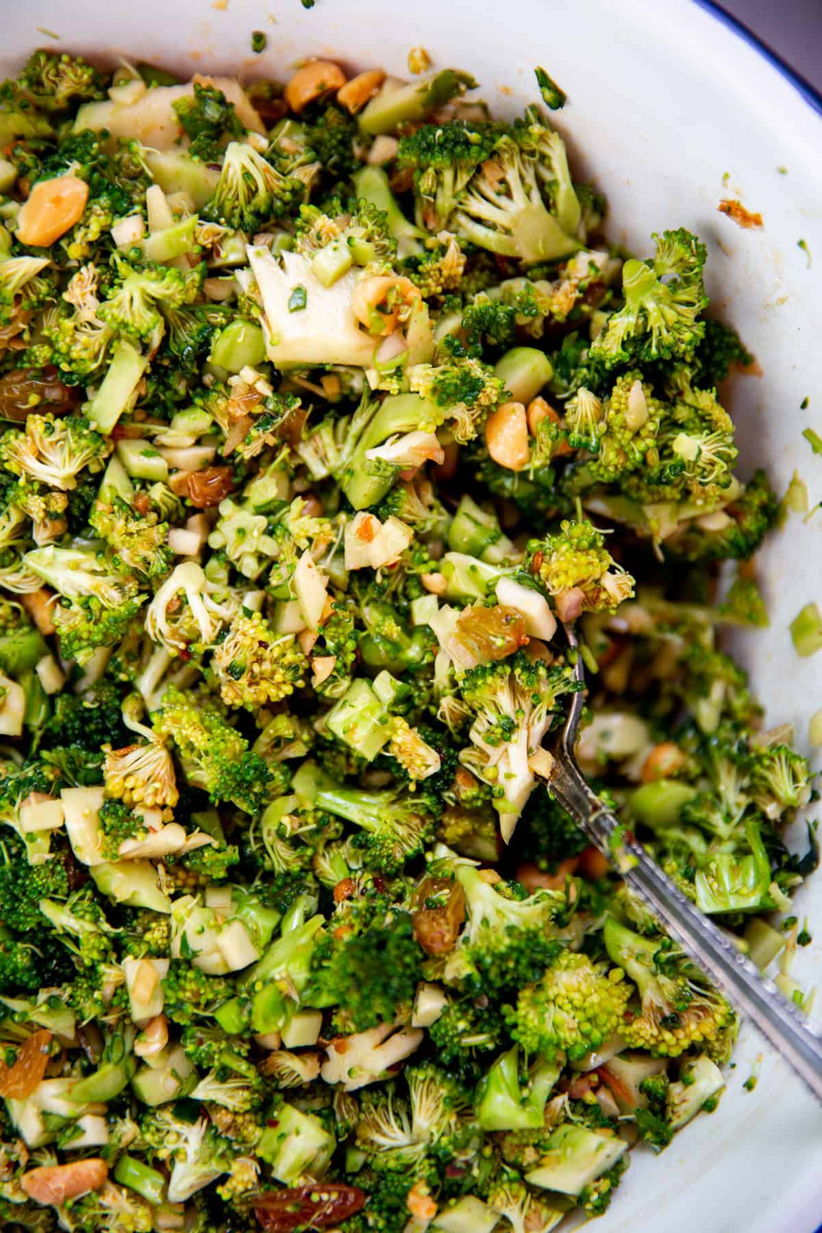 an up close shot of broccoli salad in a bowl 