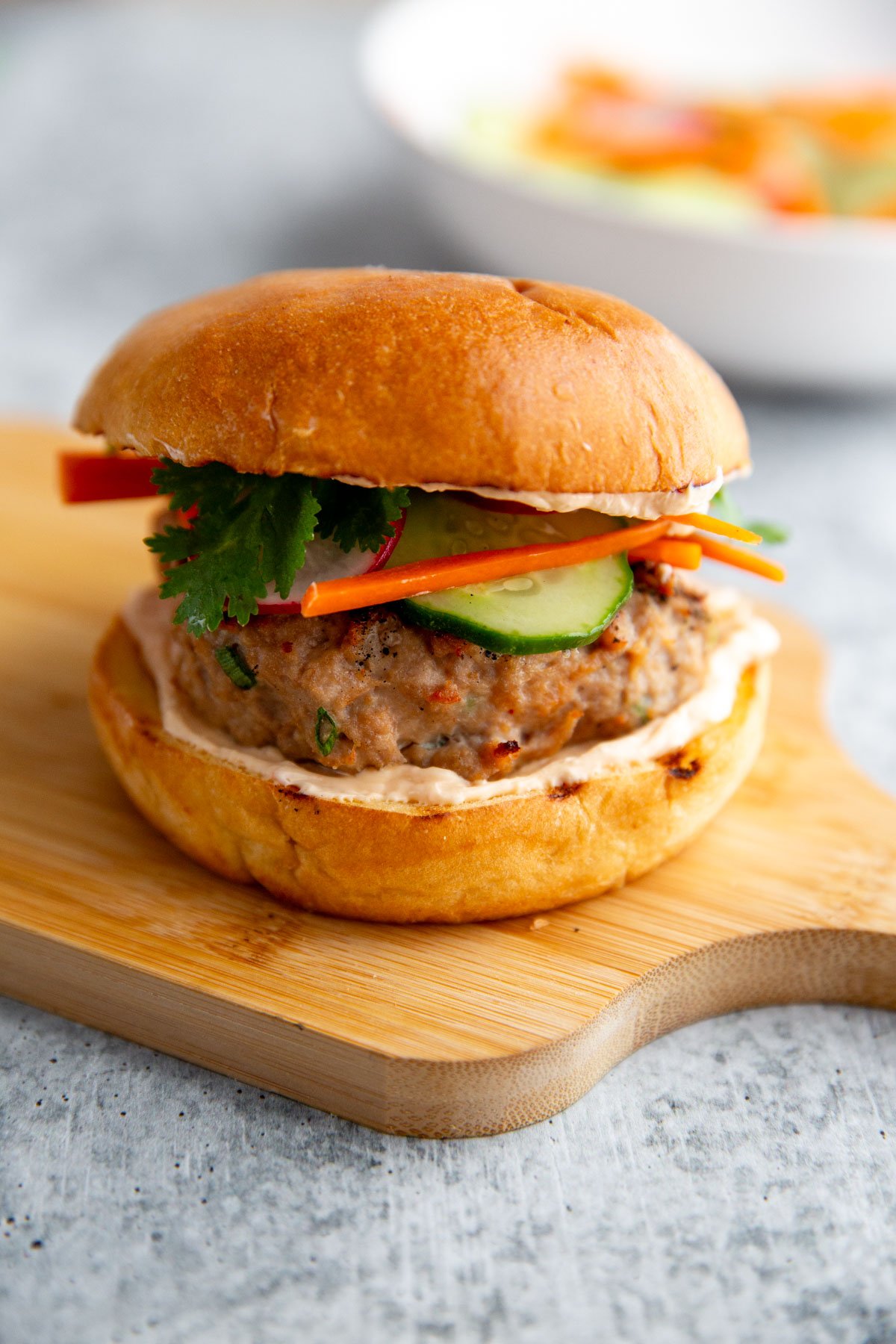 a burger on a cutting board 