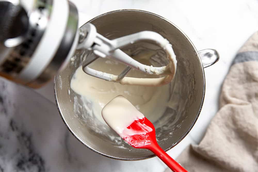 a stand mixer with glaze ingredients blended 