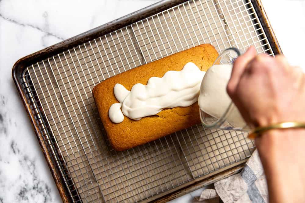 cream cheese glaze on top of a loaf cake