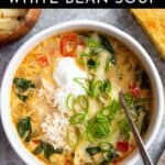 Creamy white bean soup in a bowl with toppings.