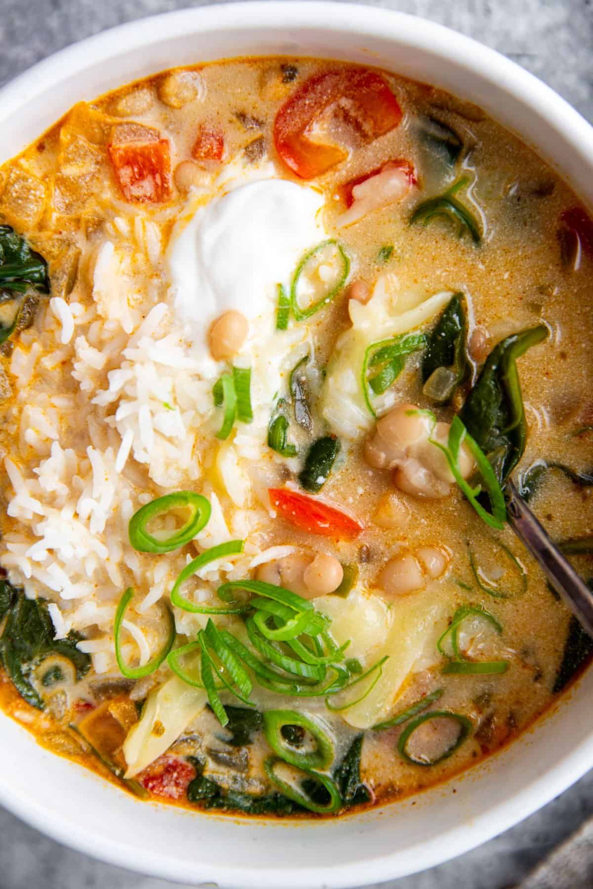 a close up of the top of a bowl of soup to show to the creamy texture and ingredients.