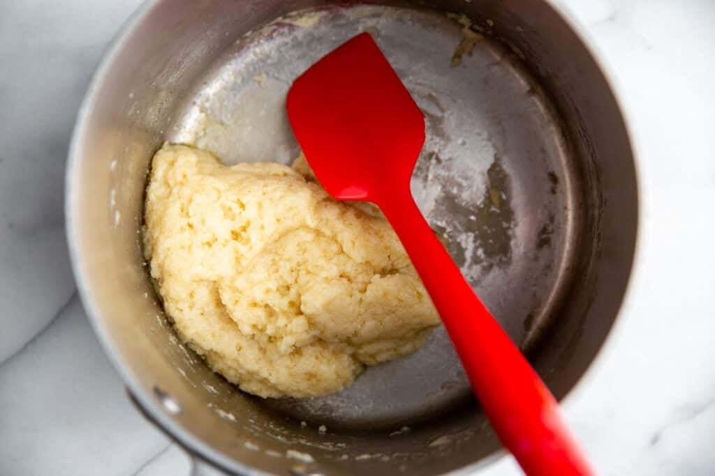 a ball of dough resting in a saucepan 