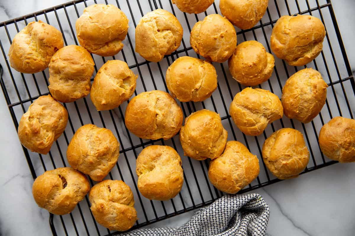 cream puff shells cooling on a wire rack