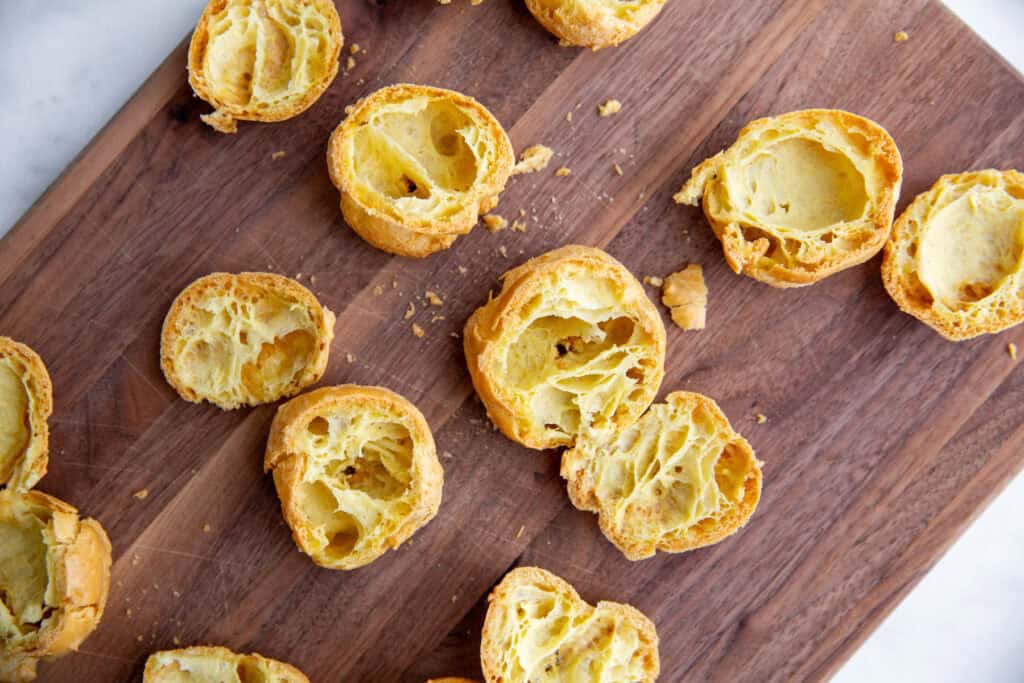 shells of baked cream puff dough on a cutting board