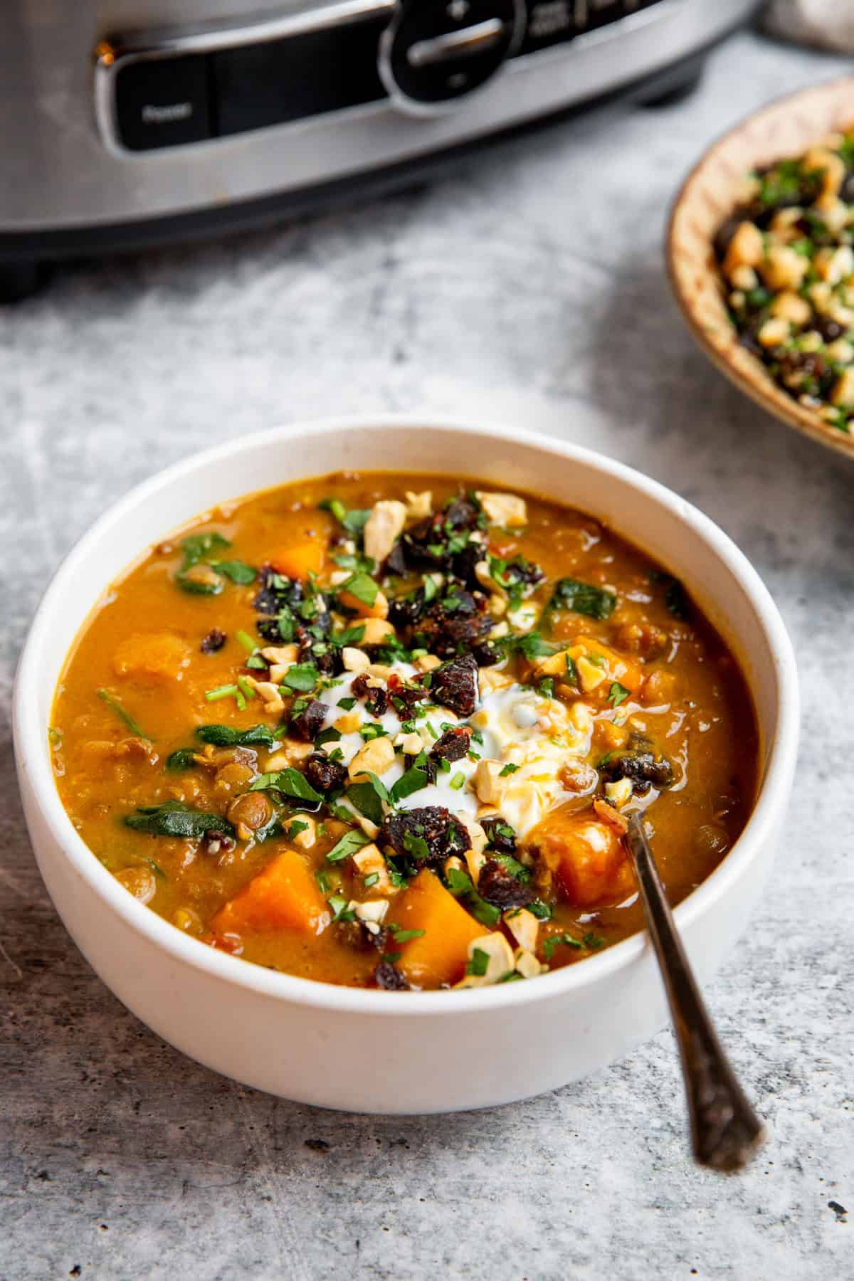 a bowl of soup with a spoon resting on the side 