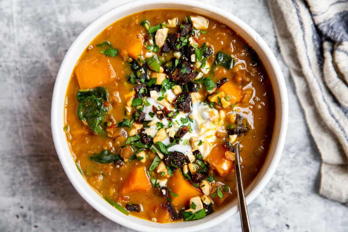 a bowl of butternut squash and lentil stew in a bowl 