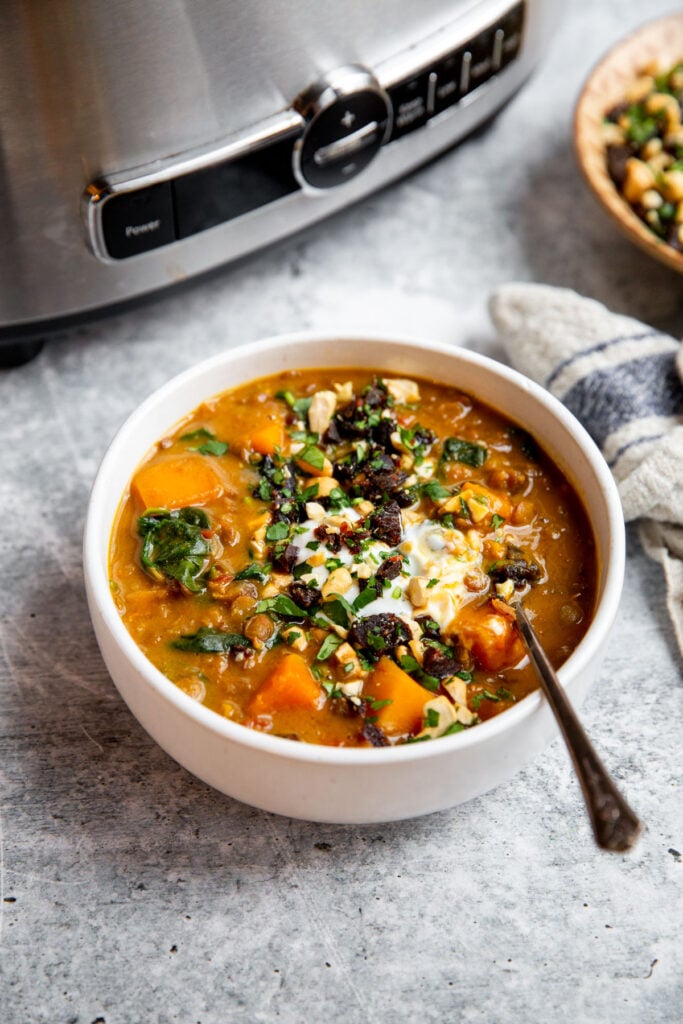 a bowl of stew topped with yogurt and gremolata