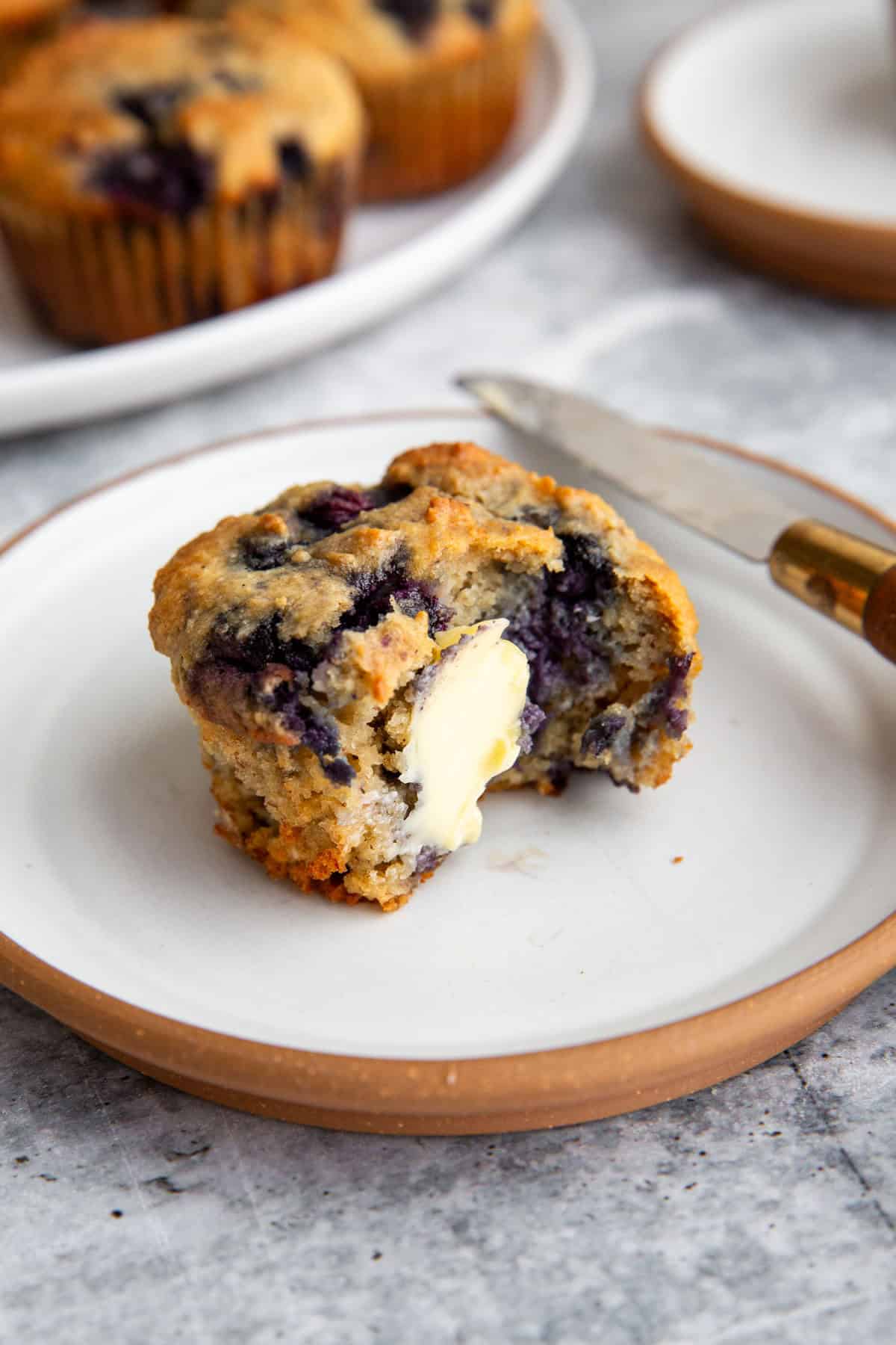 butter spread onto the inside of a gluten-free muffin.