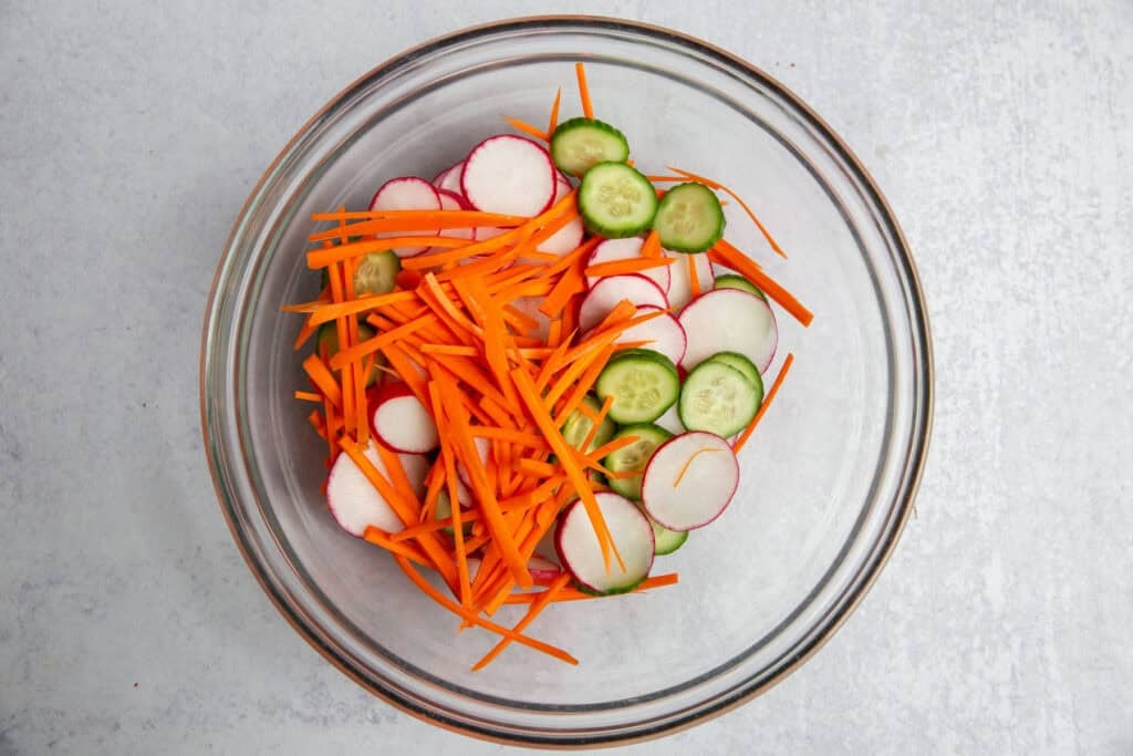 sliced vegetables in a glass bowl