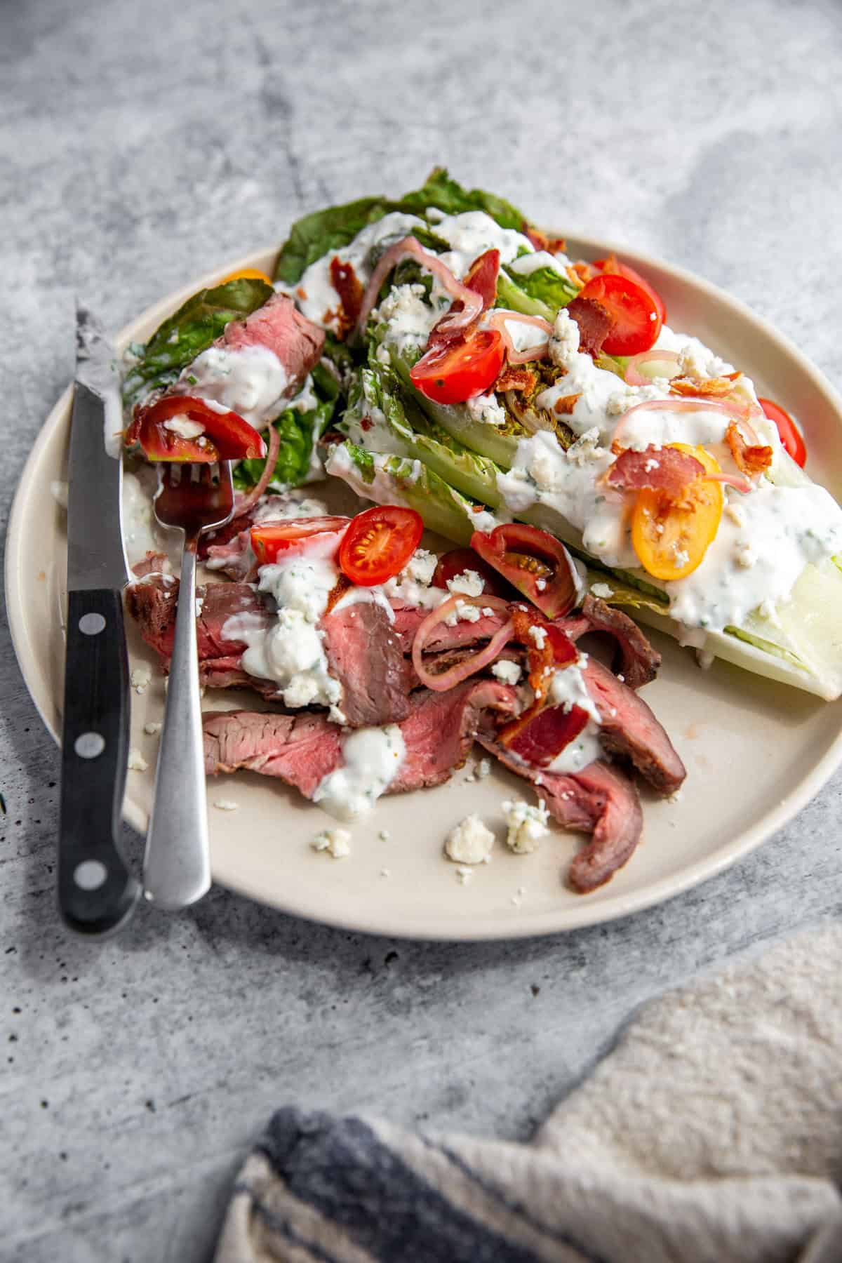Finished wedge steak salad with blue cheese crumbles and pickled shallots ready to serve