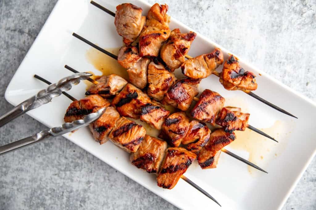 Pork kebabs grilled on barbecue until browned and caramelized