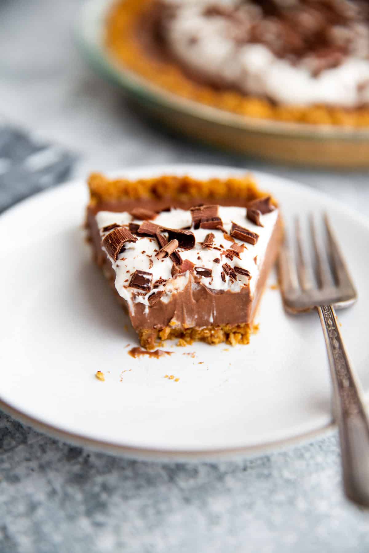 a slice of chocolate pudding pie with a bite taken out.