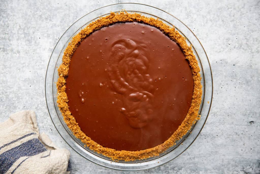 chocolate pudding poured into the graham cracker crust