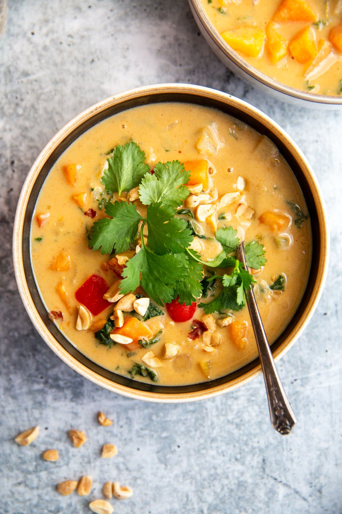 sweet potato peanut stew in a bowl topped with herbs
