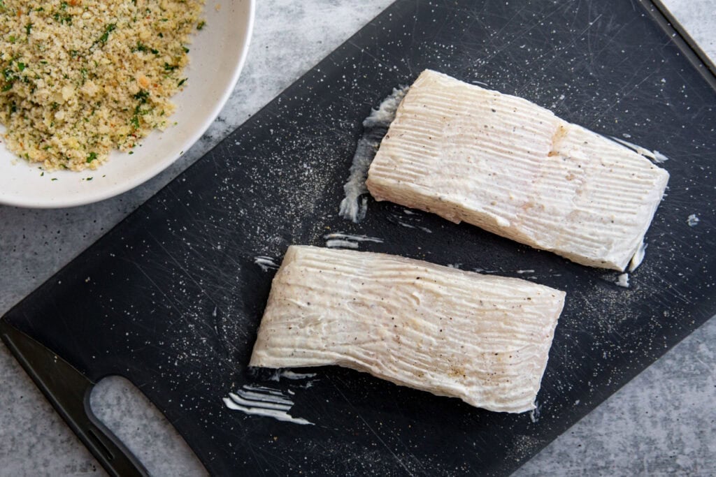 two halibut fillets rubbed with mayonnaise