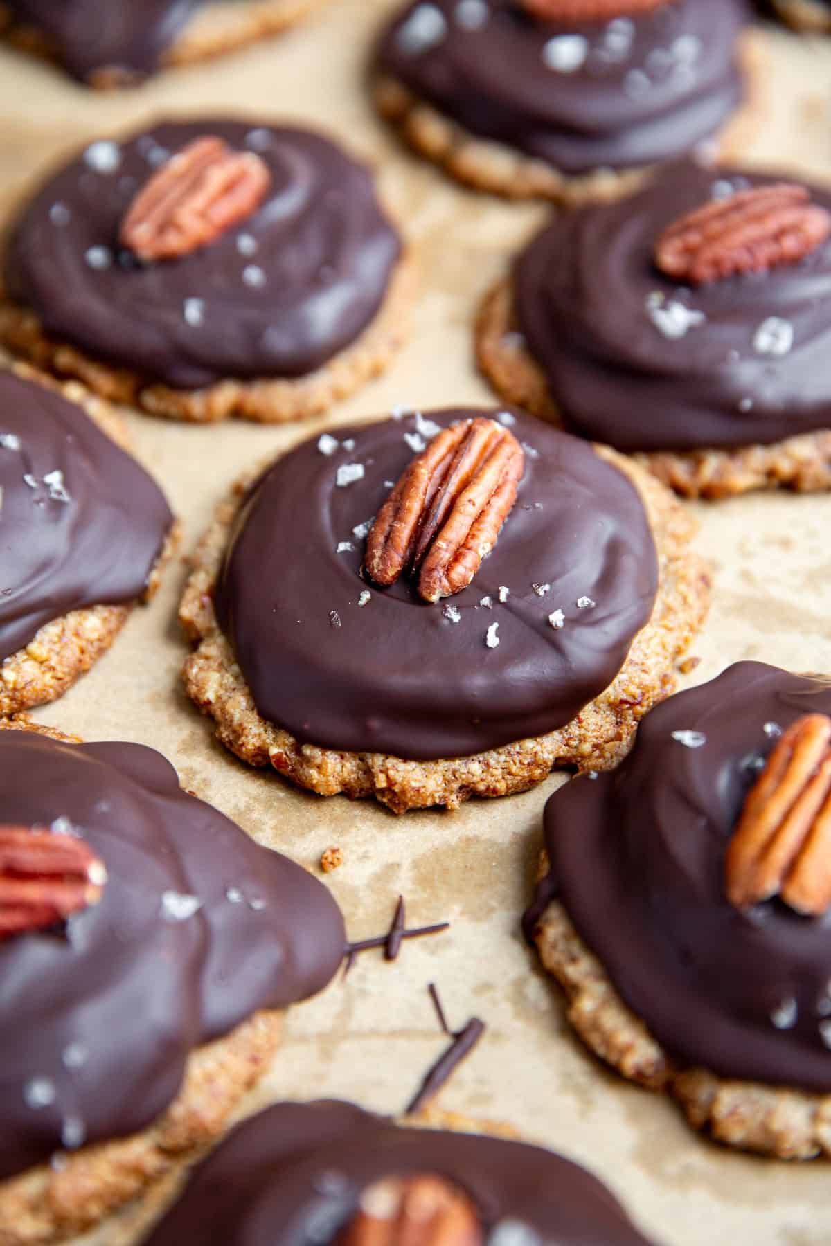 vegan chocolate turtle cookies on a piece of parchment paper after cooling in the refrigerator