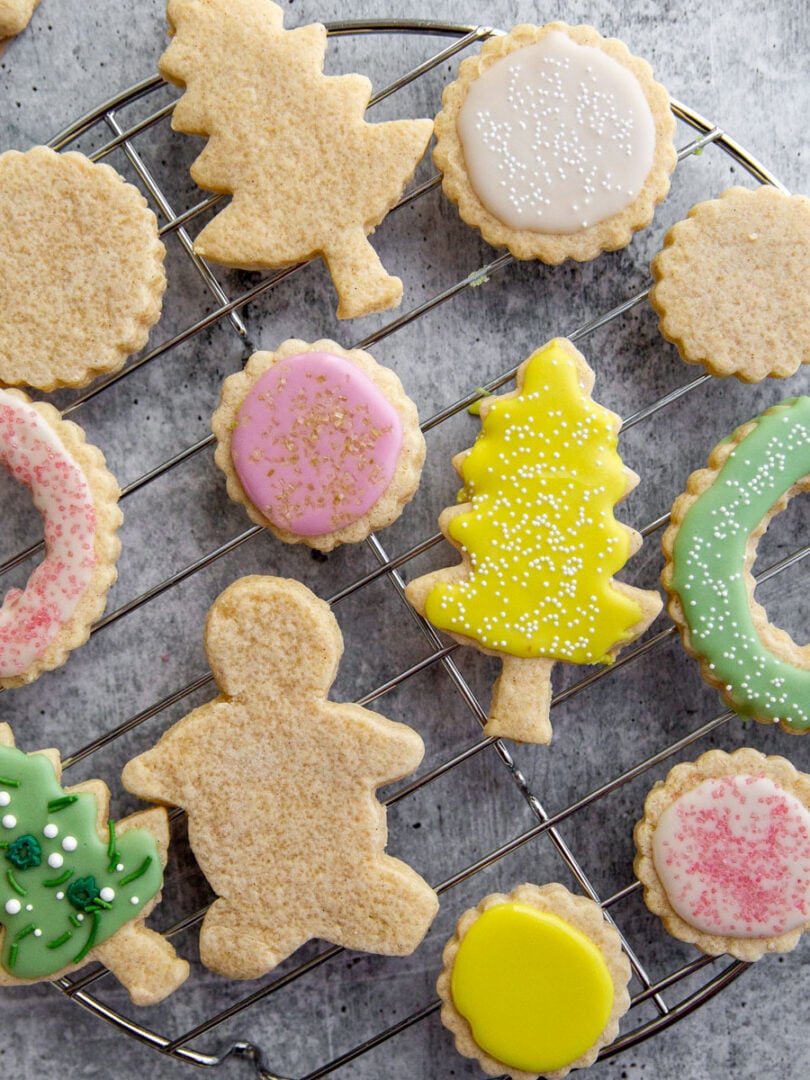 gluten-free cut out sugar cookies on a wire rack decorated with icing.