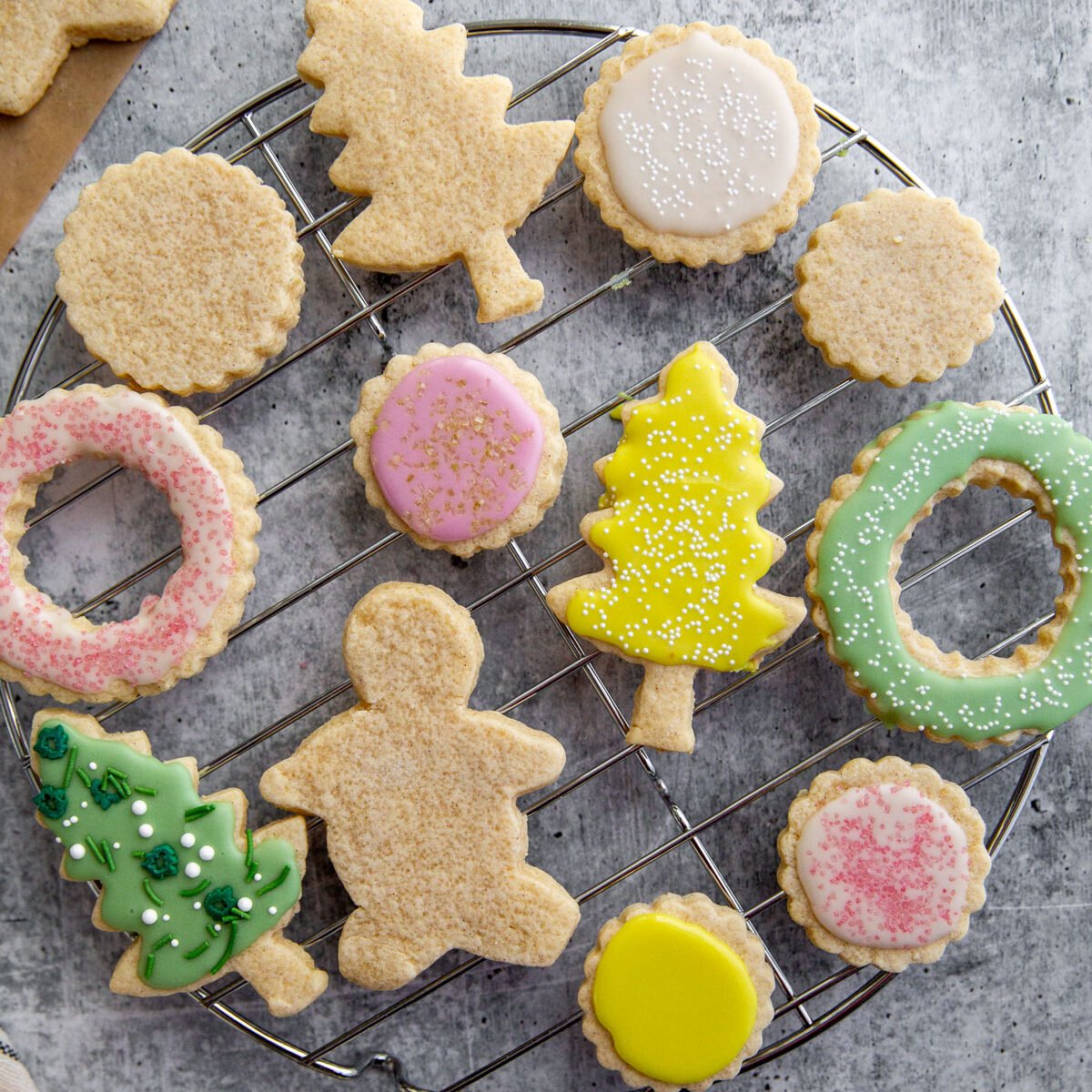 gluten-free cut out sugar cookies on a wire rack decorated with icing.