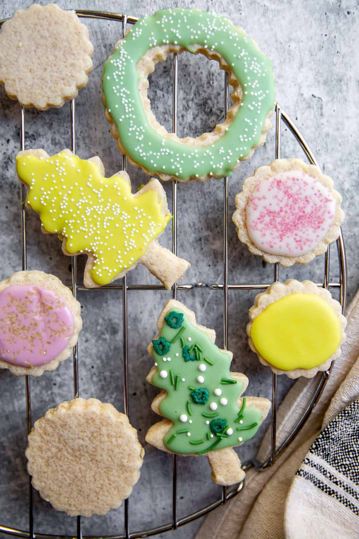 a close up of gluten-free sugar cookies decorated with icing and topped with sprinkles.