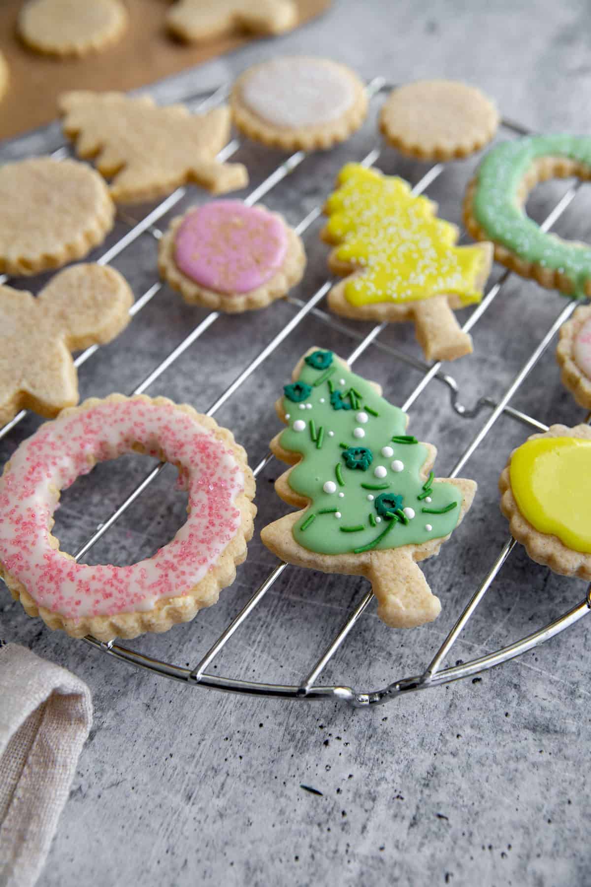 a close up of decorated sugar cookies: wreaths and christmas trees.