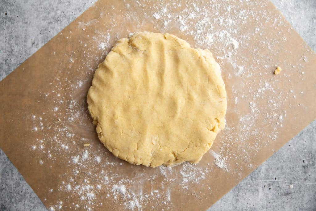 the cookie dough rolled out on a piece of parchment paper